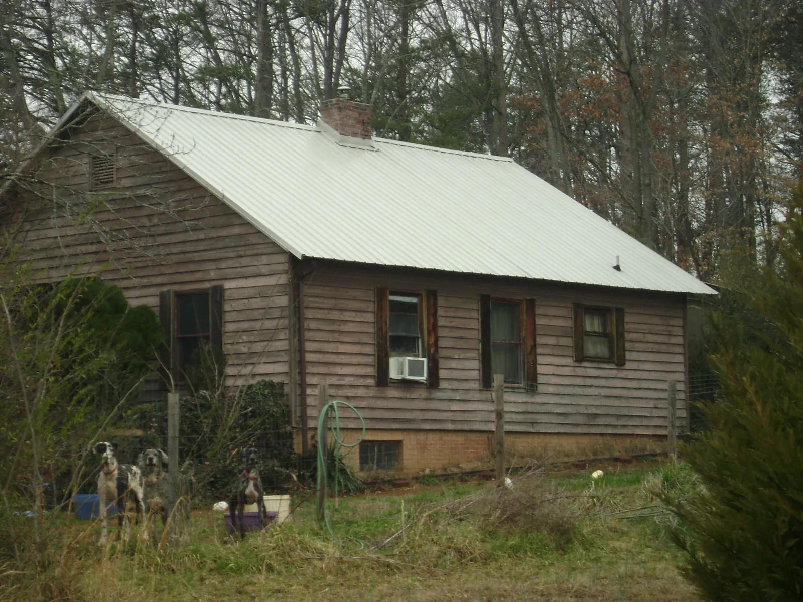 White metal roof on an old wood sided farmhouse, from a Metal Roof Installation job in Kenyon